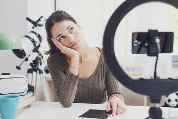 Pensive influencer sitting at desk