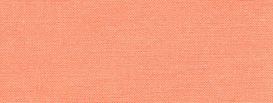Texture of coral color background from textile material with wicker pattern. Structure of peach fabric