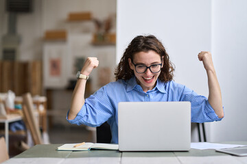 Young happy business woman office worker or student feeling excited winning online looking at...