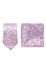 Close-up set of a purple and white tie and pocket square embossed with a floral paisley pattern. The paisley tie and pocket square are isolated on a white background. Top view.