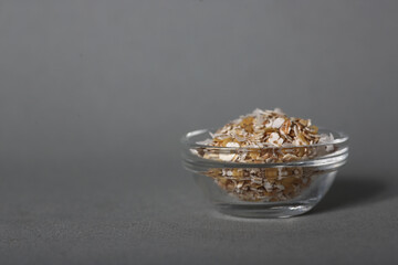 glass bowl of oatmeal isolated on gray background