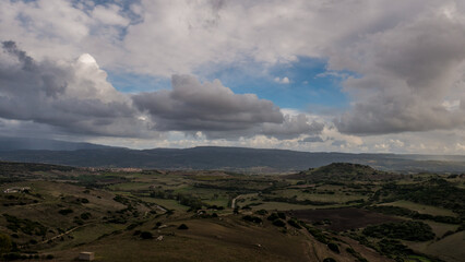 Sardinian hills with a beautiful cloudy sky view from above on the Silanis valley at sunset time