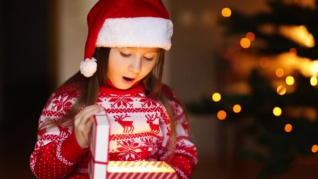 child opens magic gift box. Christmas miracle.