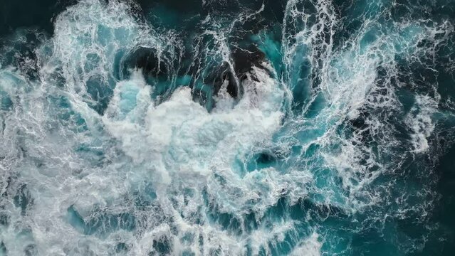 Slow motion aerial shot of powerful wave crashing. Sea or ocean big stormy surf clear turquoise water with foamy white texture