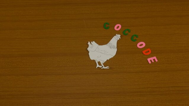 stop motion of fried egg, with drawn hen, hard-boiled egg with yellow yolk coming out on wooden cutting board. representative process of the brood of the egg up to the preparation of the food.