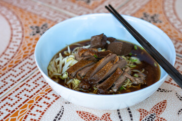 egg noodles with stewed and braised duck in brown soup - Asian food style