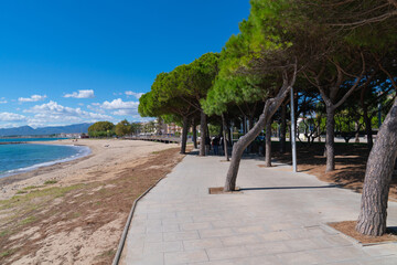 Seaside promenade Esquirol beach Cambrils Spain view towards the town Costa Dorada coast © acceleratorhams