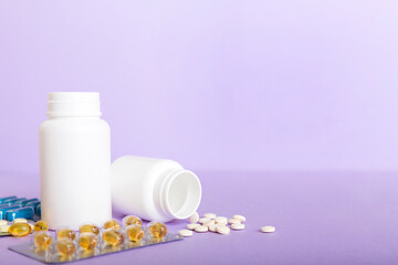 Medicine for treatment HIV infection. Pills and capsules and battle on the table. Different colorful tablets at colored background with copy space