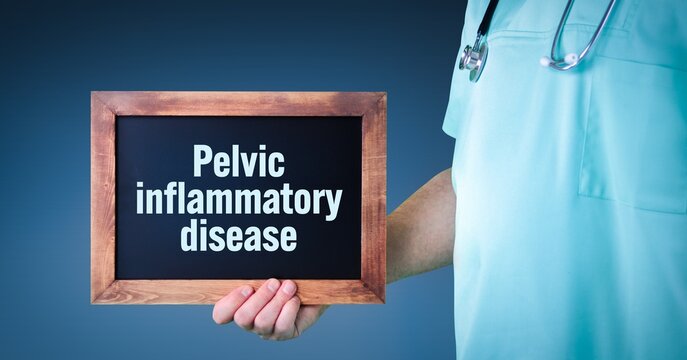 Pelvic Inflammatory Disease. Doctor Shows Sign/board With Wooden Frame. Background Blue