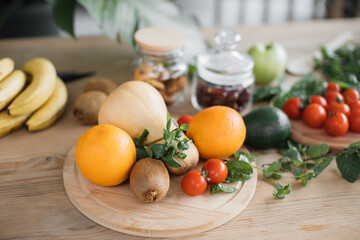 Fresh fruits and vegetables lying on wooden table, healthy lifestyle concept. Vegetarian foods background and banner of arrangement of fruits. Copy space.