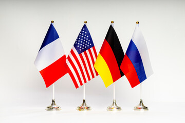 State flags of the USA, Russia, Germany and France on a light background.