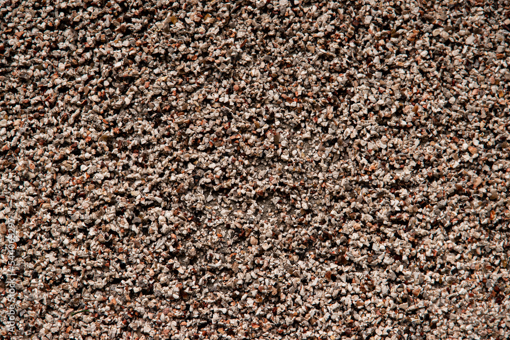 Wall mural top view of brown small stones textured rough background.