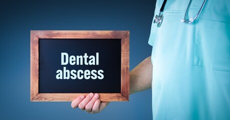 Dental abscess (periapical abscess). Doctor shows sign/board with wooden frame. Background blue - obrazy, fototapety, plakaty