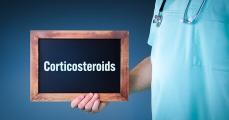 Corticosteroids. Doctor shows sign/board with wooden frame. Background blue