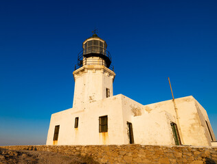 Armenistis old lighthouse, in Mykonos island,  with a. deep blue sky background