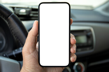 man hand holds phone with isolated screen on background car
