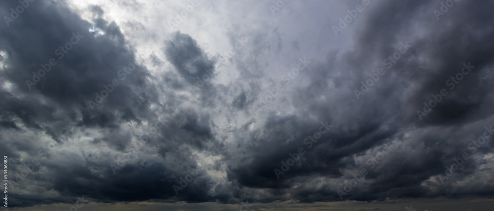Poster The dark sky with heavy clouds converging and a violent storm before the rain.Bad or moody weather sky and environment. carbon dioxide emissions, greenhouse effect, global warming, climate change