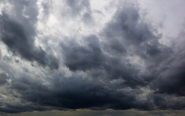 The dark sky with heavy clouds converging and a violent storm before the rain.Bad or moody weather...