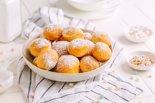 Cottage cheese donuts balls with sugar in a bowl. Healthy curd dessert.