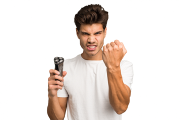 Young caucasian man holding a razor isolated showing fist to camera, aggressive facial expression.