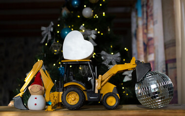 concept of christmas business greetings, new year holidays in construction company. toy bulldozer...