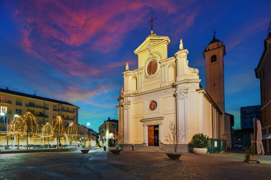 Catholic church on town square in the evening in Alba, Italy.
