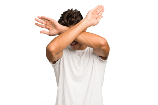 Young caucasian handsome man isolated keeping two arms crossed, denial concept.