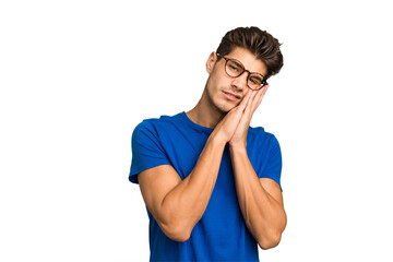 Young caucasian handsome man isolated yawning showing a tired gesture covering mouth with hand.