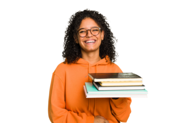 Young student woman holding a pile of books isolated laughing and having fun.