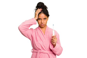 Young brazilian woman holding an electric toothbrush isolated being shocked, she has remembered important meeting.