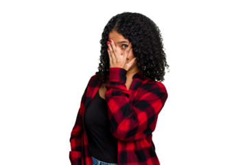 Young cute brazilian woman isolated blink at the camera through fingers, embarrassed covering face.