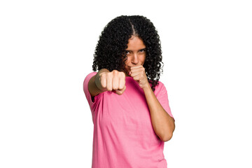 Fototapeta na wymiar Young cute brazilian woman isolated throwing a punch, anger, fighting due to an argument, boxing.