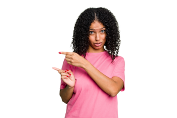 Young cute brazilian woman isolated pointing with forefingers to a copy space, expressing excitement and desire.