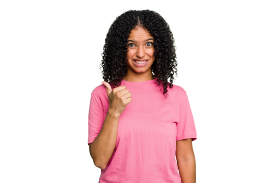 Young cute brazilian woman isolated shocked pointing with index fingers to a copy space.