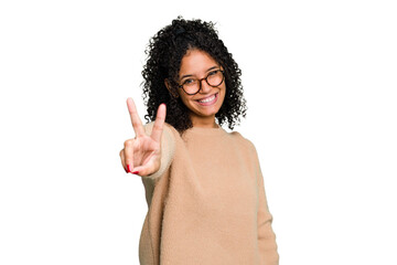 Young cute brazilian woman isolated joyful and carefree showing a peace symbol with fingers.