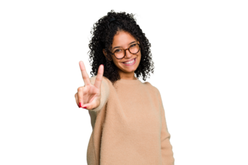 Young cute brazilian woman isolated joyful and carefree showing a peace symbol with fingers.