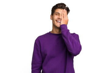 Young caucasian handsome man isolated having fun covering half of face with palm.