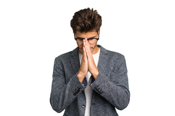 Young caucasian handsome man isolated praying, showing devotion, religious person looking for...