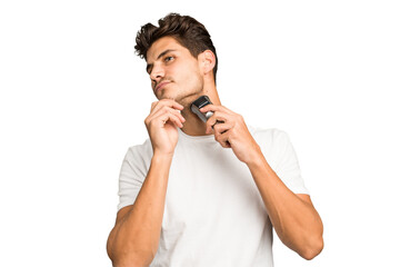 Young caucasian man shaving his beard with a razor isolated