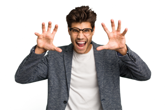 Young caucasian handsome man isolated showing claws imitating a cat, aggressive gesture.