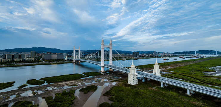 Beautiful bridge and river with city skylinen at sunset in Zhoushan, Zhejiang, China.