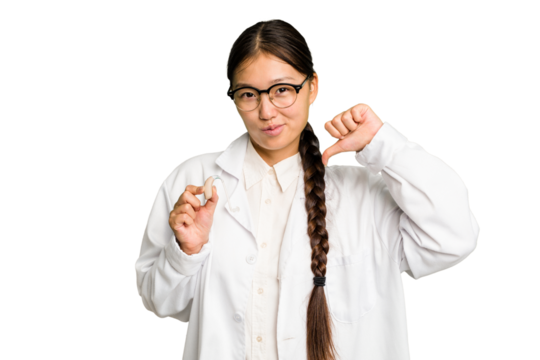 Young asian otorhinolaryngologist woman holding a hearing aid isolated feels proud and self confident, example to follow.