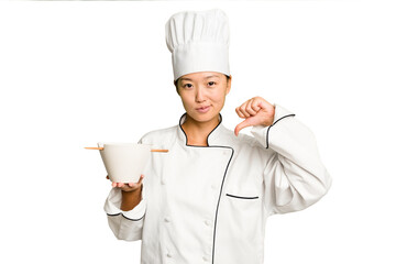 Young chef asian woman holding a bowl of ramen isolated feels proud and self confident, example to...