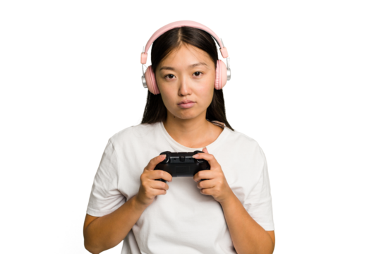 Young asian gamer woman playing with a game controller and headphones isolated