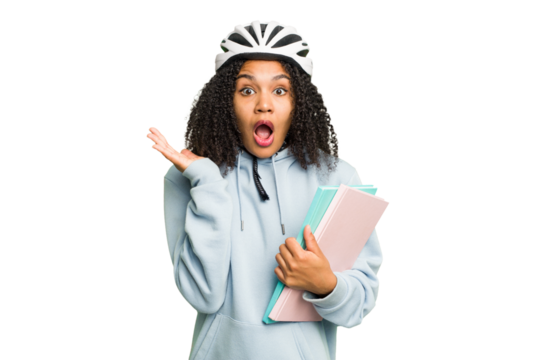 Young african american student woman wearing a helmet bike isolated surprised and shocked.