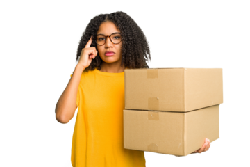 Young african american woman moving to other house while picking up a box full of things isolated pointing temple with finger, thinking, focused on a task.