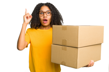 Young african american woman moving to other house while picking up a box full of things isolated having an idea, inspiration concept.
