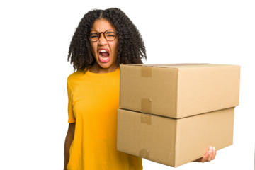 Young african american woman moving to other house while picking up a box full of things isolated screaming very angry and aggressive.