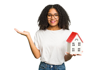 Young african american woman moving to a new home while picking up a box full of things isolated...