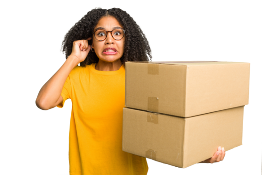 Young african american woman moving to other house while picking up a box full of things isolated covering ears with hands. - Powered by Adobe